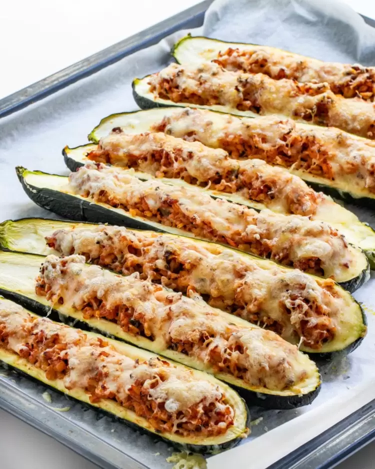 stuffed zucchini boats on a baking sheet